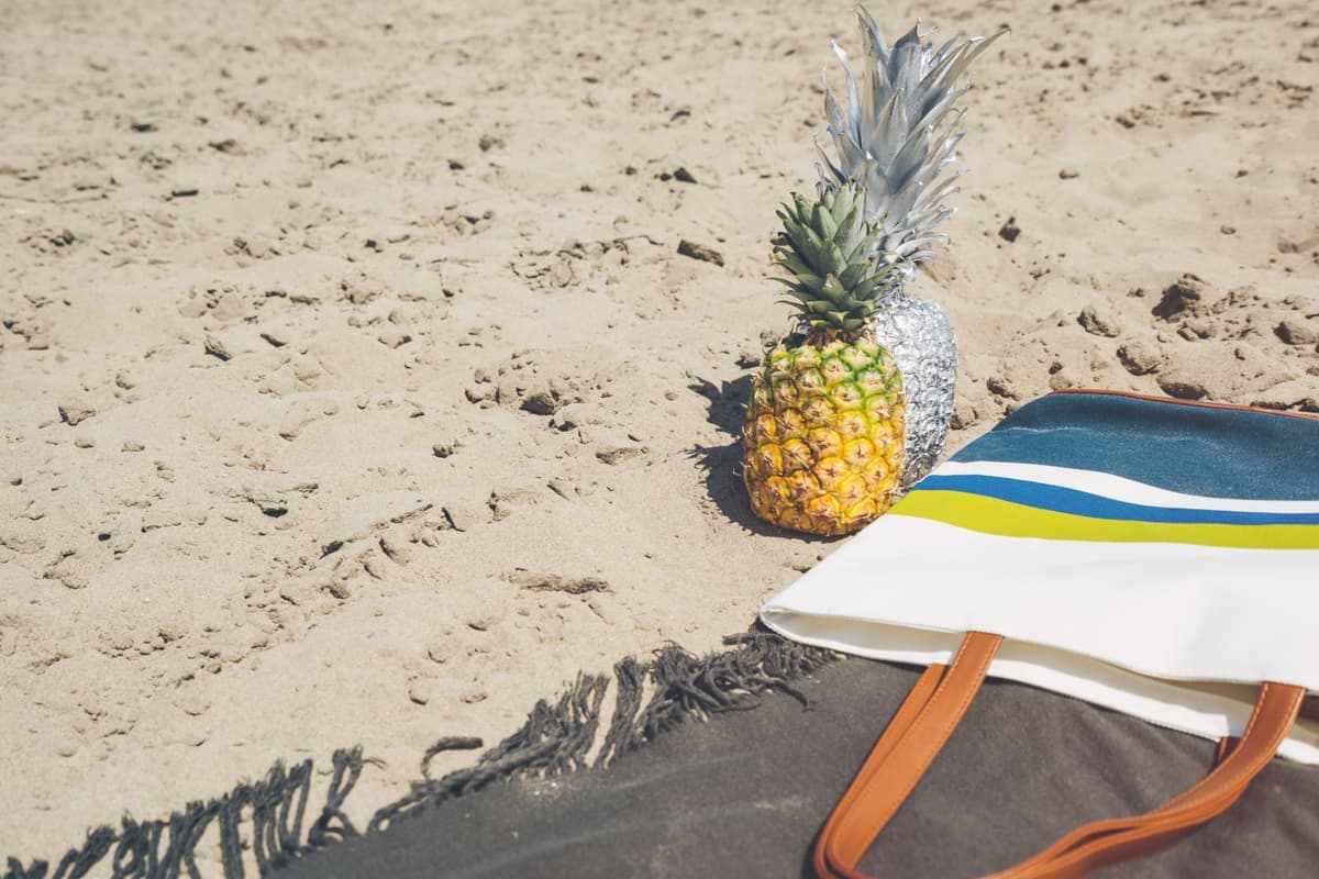 A beach tote bag packed with a towel