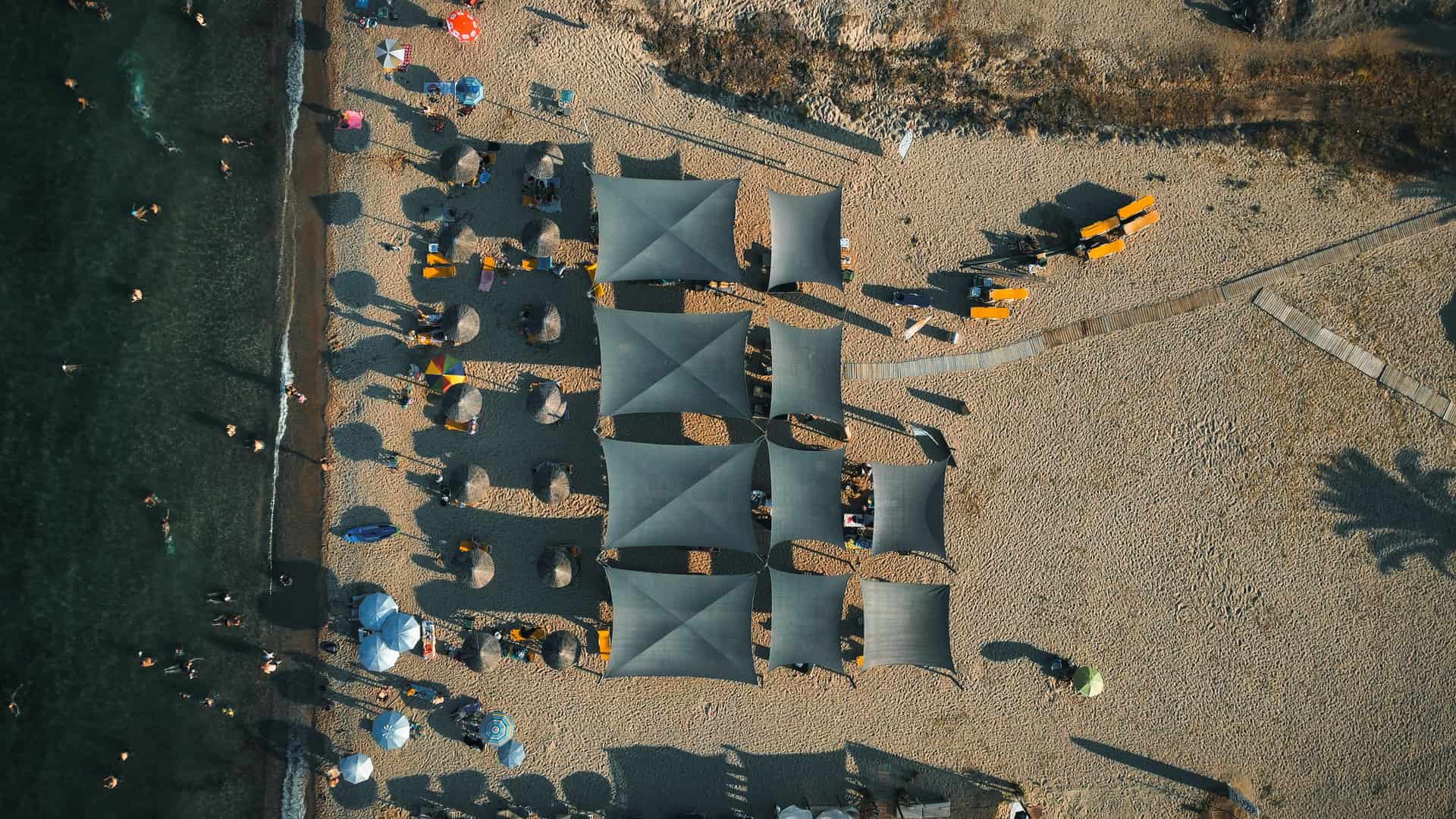 A beach canopy pitched on open sand